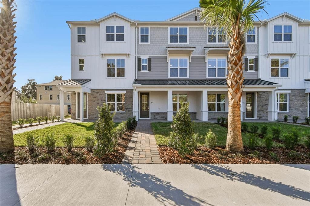 Front exterior of a new home in Townes at Northlake, Oviedo, FL, highlighting curb appeal (Image 1). Front exterior of a new home in Townes at Northlake, Oviedo, FL, highlighting curb appeal (Image 1).