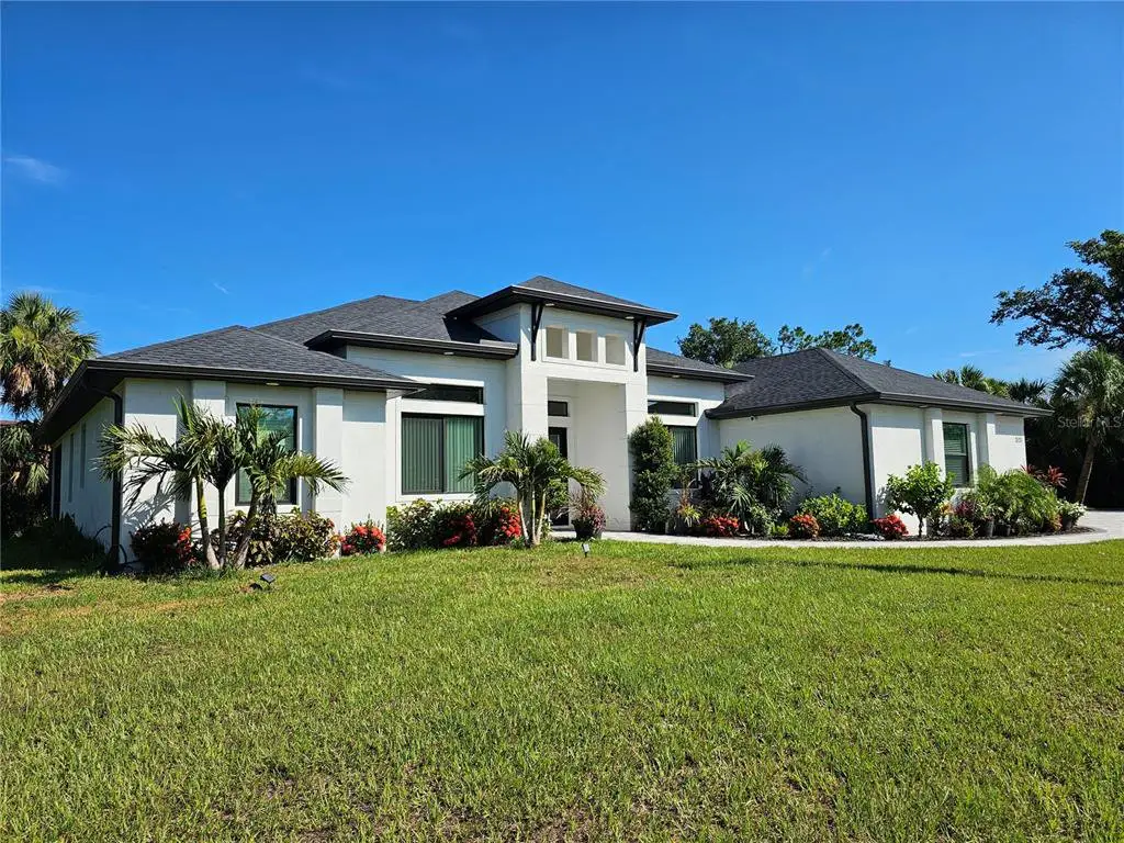Front exterior of a new home in , North Port, FL, highlighting curb appeal (Image 1). Front exterior of a new home in , North Port, FL, highlighting curb appeal (Image 1).