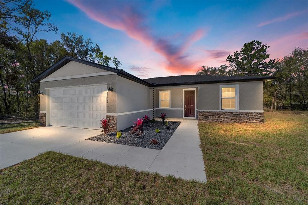 Front exterior of a new home in , Summerfield, FL, highlighting curb appeal (Image 1). Front exterior of a new home in , Summerfield, FL, highlighting curb appeal (Image 1).