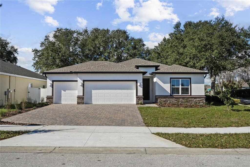 Front exterior of a new home in , Groveland, FL, highlighting curb appeal (Image 1). Front exterior of a new home in , Groveland, FL, highlighting curb appeal (Image 1).