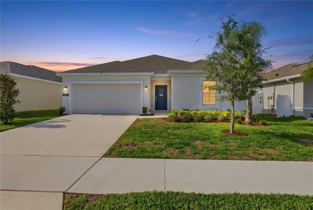Front exterior of a new home in Vineland Reserve, Osteen, FL, highlighting curb appeal (Image 1). Front exterior of a new home in Vineland Reserve, Osteen, FL, highlighting curb appeal (Image 1).
