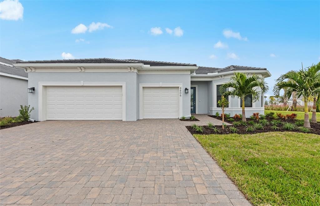 Front exterior of a new home in Del Webb Catalina, Lakewood Ranch, FL, highlighting curb appeal (Image 1). Front exterior of a new home in Del Webb Catalina, Lakewood Ranch, FL, highlighting curb appeal (Image 1).