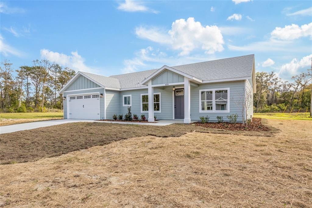 Front exterior of a new home in , Newberry, FL, highlighting curb appeal (Image 1). Front exterior of a new home in , Newberry, FL, highlighting curb appeal (Image 1).