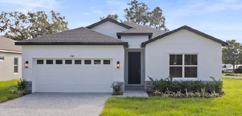 Front exterior of a new home in , Leesburg, FL, highlighting curb appeal (Image 1). Front exterior of a new home in , Leesburg, FL, highlighting curb appeal (Image 1).
