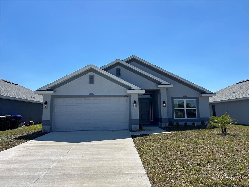 Front exterior of a new home in Watercress Cove, North Port, FL, highlighting curb appeal (Image 1). Front exterior of a new home in Watercress Cove, North Port, FL, highlighting curb appeal (Image 1).