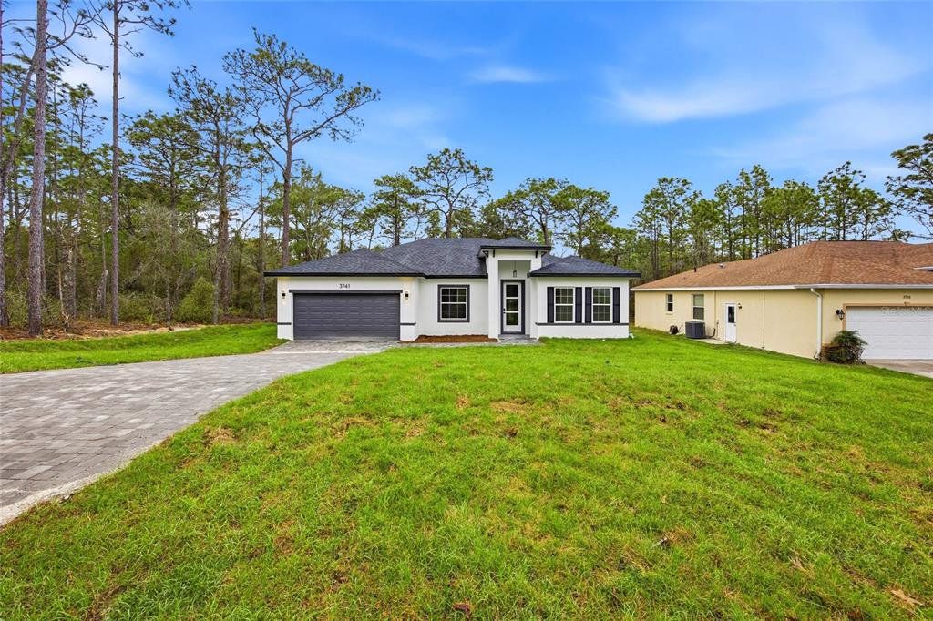 Front exterior of a new home in , Citrus Springs, FL, highlighting curb appeal (Image 1). Front exterior of a new home in , Citrus Springs, FL, highlighting curb appeal (Image 1).