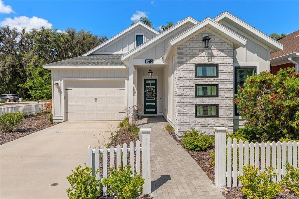 Front exterior of a new home in Fairway Pointe at West End, Newberry, FL, highlighting curb appeal (Image 1). Front exterior of a new home in Fairway Pointe at West End, Newberry, FL, highlighting curb appeal (Image 1).
