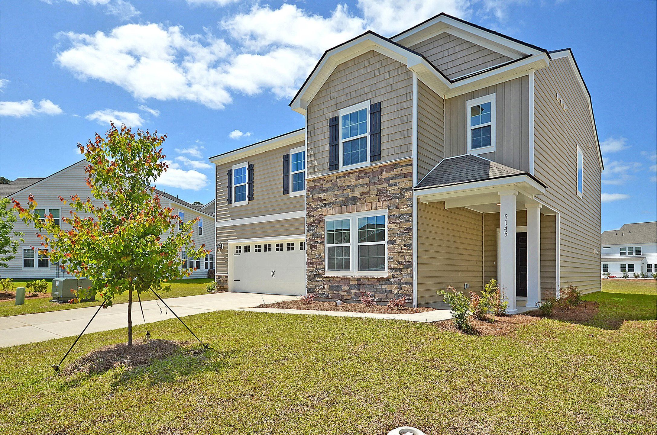 Front exterior of a new home in Cypress Preserve: Arbor Collection, Moncks Corner, SC, highlighting curb appeal (Image 1). Front exterior of a new home in Cypress Preserve: Arbor Collection, Moncks Corner, SC, highlighting curb appeal (Image 1).