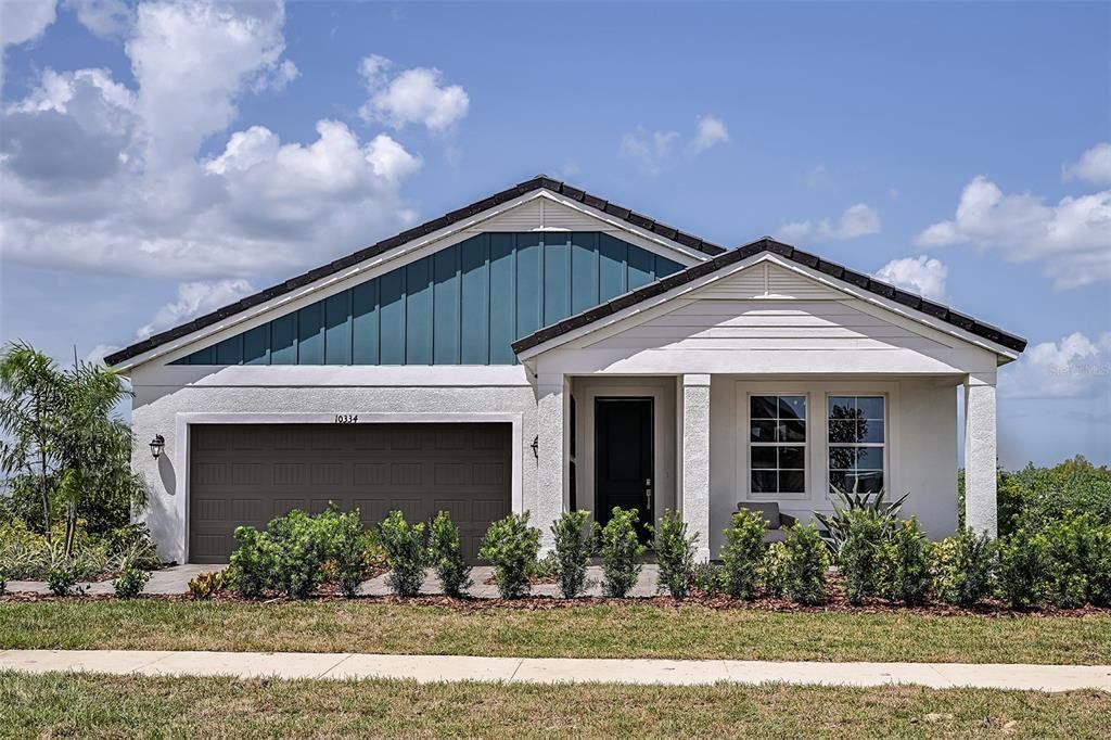 Front exterior of a new home in Pasadena Woods, Wesley Chapel, FL, highlighting curb appeal (Image 1).