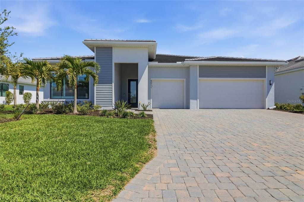 Front exterior of a new home in , Lakewood Ranch, FL, highlighting curb appeal (Image 1). Front exterior of a new home in , Lakewood Ranch, FL, highlighting curb appeal (Image 1).