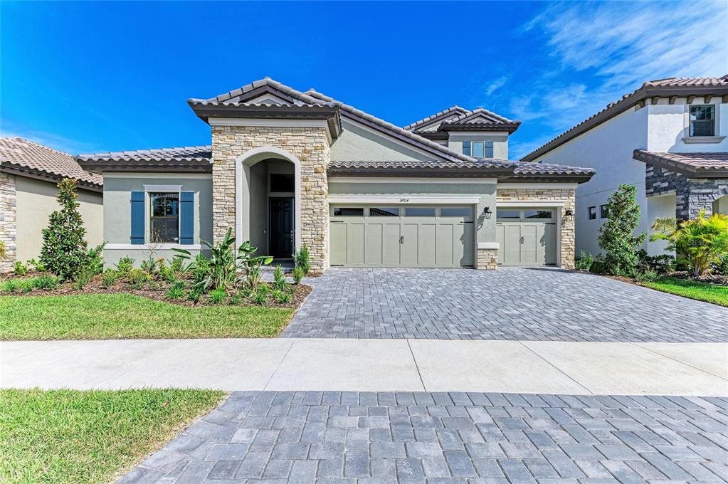 Front exterior of a new home in Hawkstone, Lithia, FL, highlighting curb appeal (Image 1). Front exterior of a new home in Hawkstone, Lithia, FL, highlighting curb appeal (Image 1).