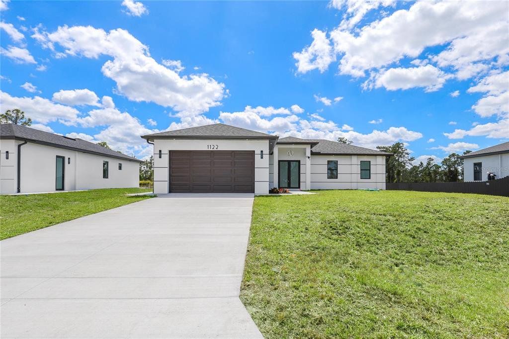 Front exterior of a new home in , Lehigh Acres, FL, highlighting curb appeal (Image 1). Front exterior of a new home in , Lehigh Acres, FL, highlighting curb appeal (Image 1).