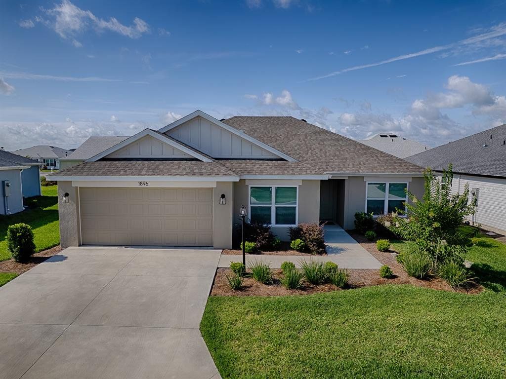 Front exterior of a new home in , The Villages, FL, highlighting curb appeal (Image 1). Front exterior of a new home in , The Villages, FL, highlighting curb appeal (Image 1).