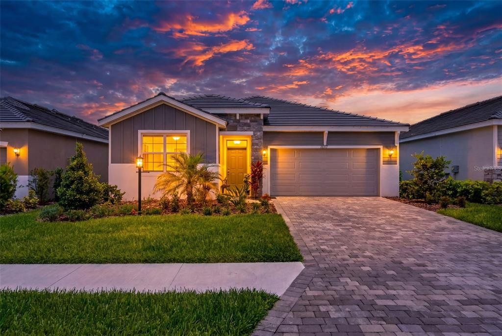 Front exterior of a new home in Star Farms at Lakewood Ranch, Bradenton, FL, highlighting curb appeal (Image 1). Front exterior of a new home in Star Farms at Lakewood Ranch, Bradenton, FL, highlighting curb appeal (Image 1).