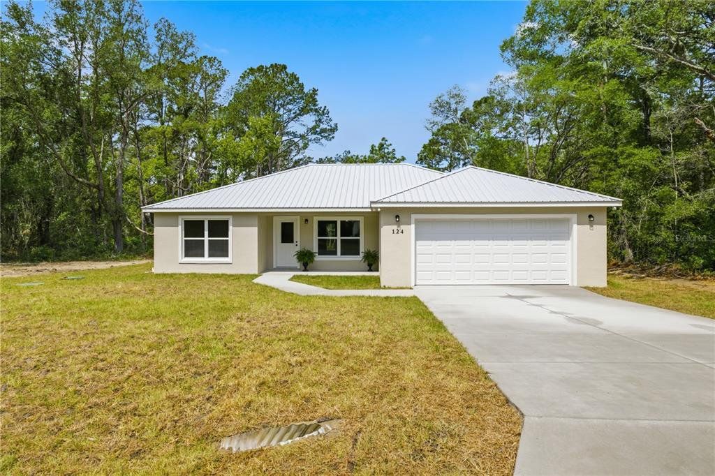 Front exterior of a new home in , Ocklawaha, FL, highlighting curb appeal (Image 1). Front exterior of a new home in , Ocklawaha, FL, highlighting curb appeal (Image 1).