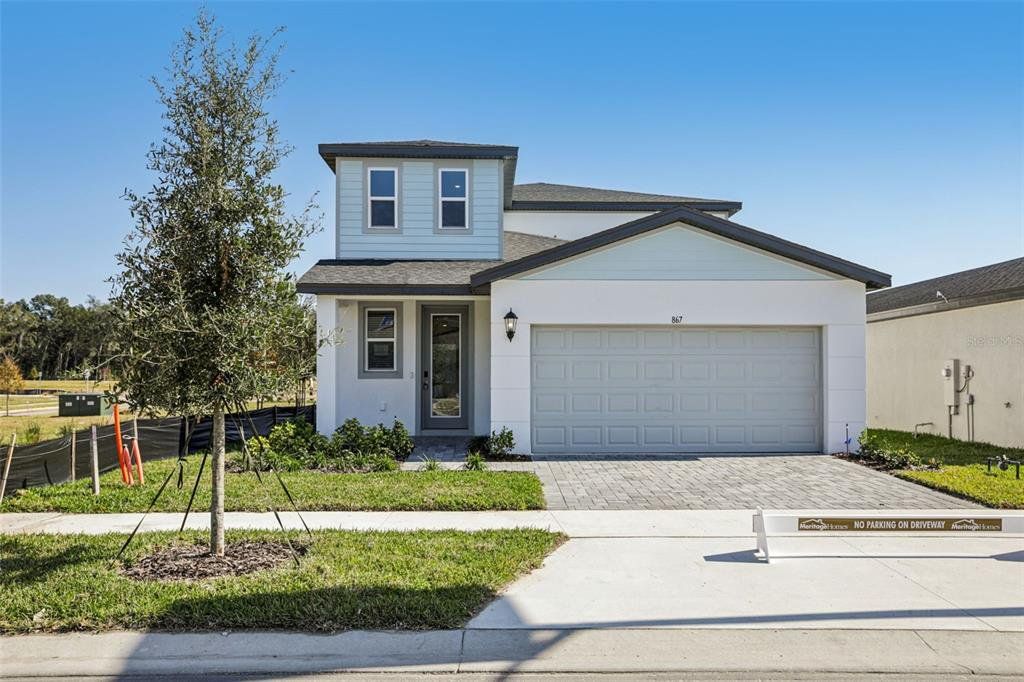 Front exterior of a new home in The Reserve at Hammock Oaks - Classic Series, Lady Lake, FL, highlighting curb appeal (Image 1). Front exterior of a new home in The Reserve at Hammock Oaks - Classic Series, Lady Lake, FL, highlighting curb appeal (Image 1).