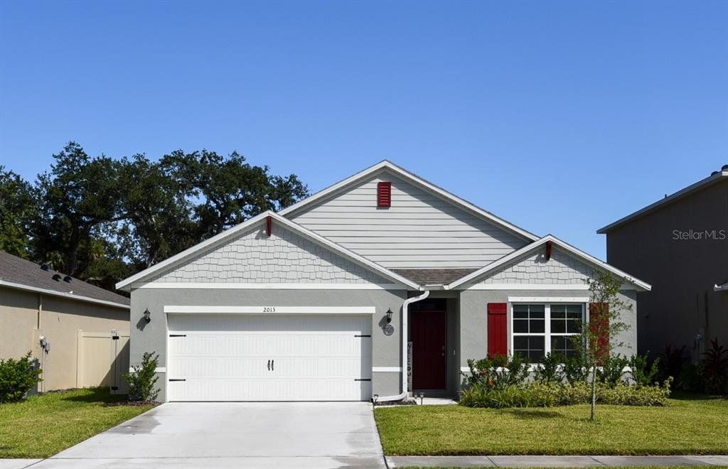 Front exterior of a new home in Oak Leaf Preserve, New Smyrna Beach, FL, highlighting curb appeal (Image 1). Front exterior of a new home in Oak Leaf Preserve, New Smyrna Beach, FL, highlighting curb appeal (Image 1).