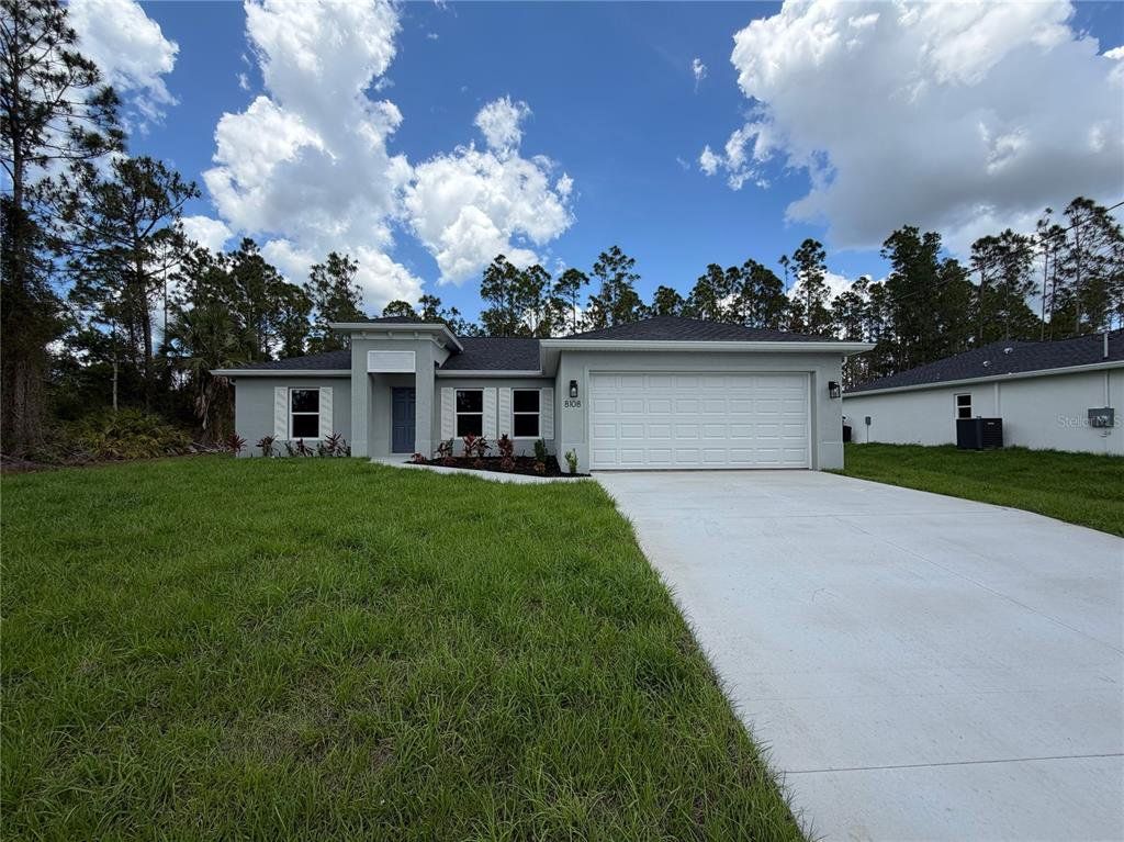 Front exterior of a new home in , North Port, FL, highlighting curb appeal (Image 1). Front exterior of a new home in , North Port, FL, highlighting curb appeal (Image 1).