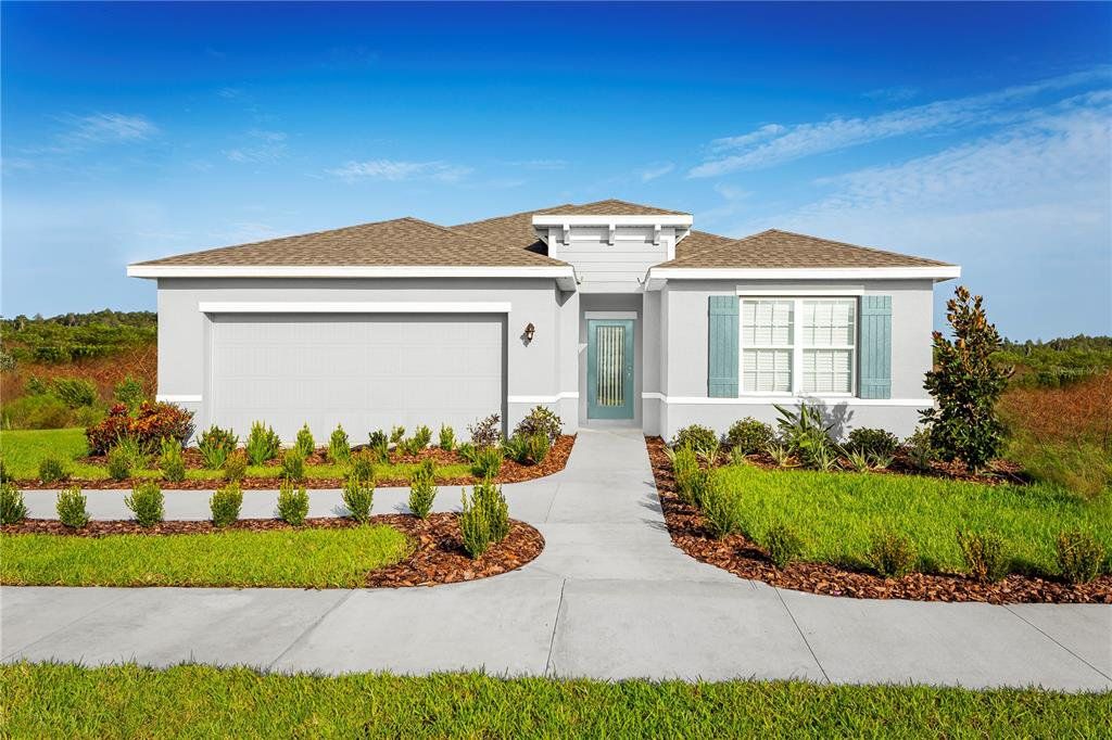 Front exterior of a new home in Overlook at Grassy Lake, Minneola, FL, highlighting curb appeal (Image 1). Front exterior of a new home in Overlook at Grassy Lake, Minneola, FL, highlighting curb appeal (Image 1).