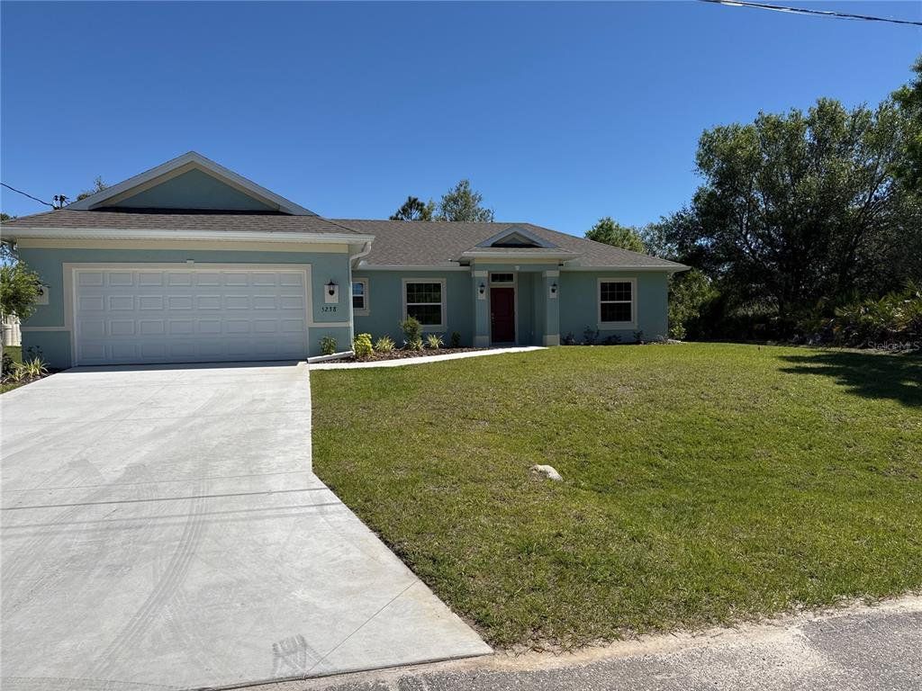 Front exterior of a new home in , North Port, FL, highlighting curb appeal (Image 1). Front exterior of a new home in , North Port, FL, highlighting curb appeal (Image 1).