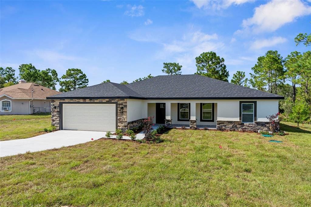 Front exterior of a new home in , Weeki Wachee, FL, highlighting curb appeal (Image 1). Front exterior of a new home in , Weeki Wachee, FL, highlighting curb appeal (Image 1).
