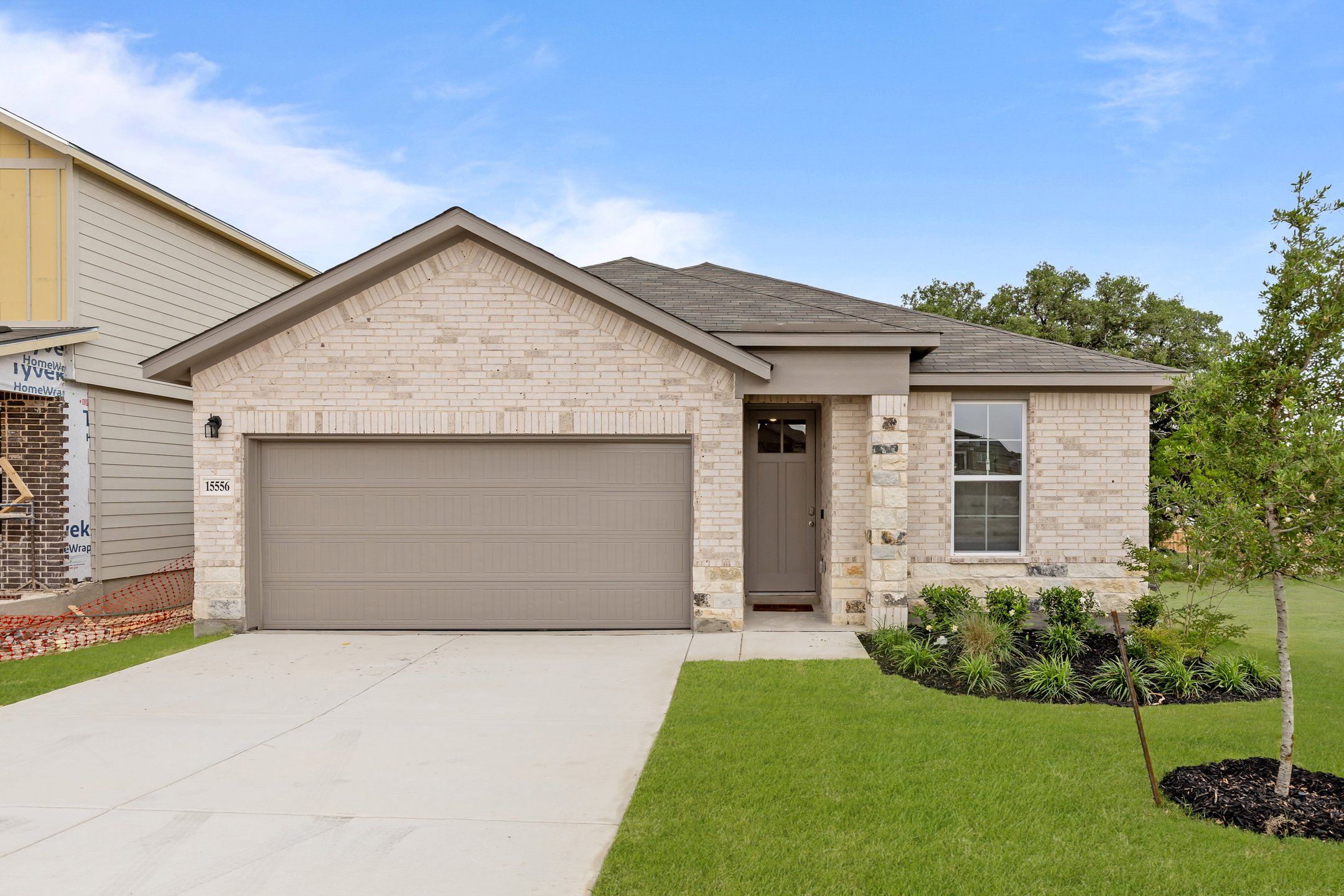 Front exterior of a new home in Hunter's Ranch, San Antonio, TX, highlighting curb appeal (Image 1).