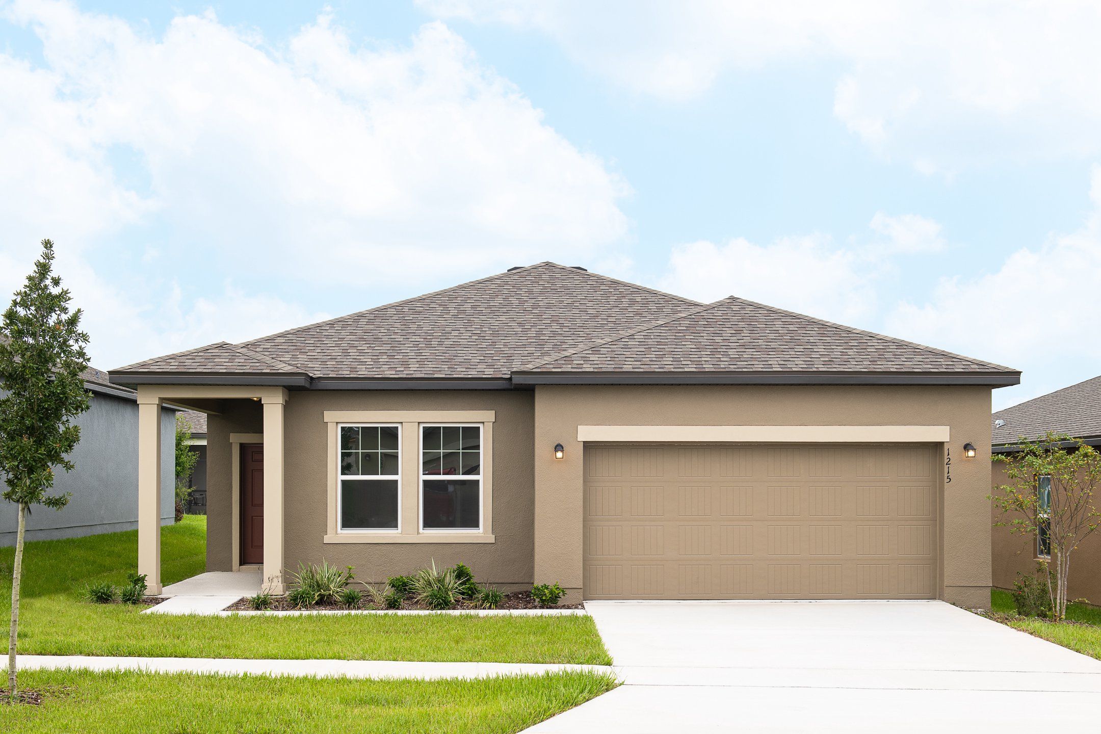 Front exterior of a new home in Sunset Hills, Winter Haven, FL, highlighting curb appeal (Image 1).