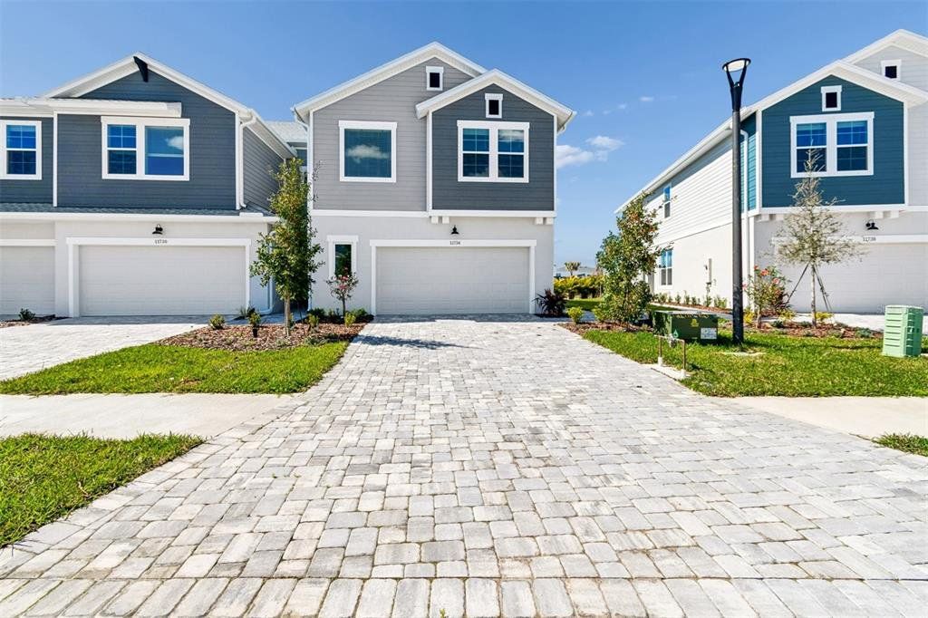 Front exterior of a new home in North River Ranch – Townhomes, Parrish, FL, highlighting curb appeal (Image 1). Front exterior of a new home in North River Ranch – Townhomes, Parrish, FL, highlighting curb appeal (Image 1).