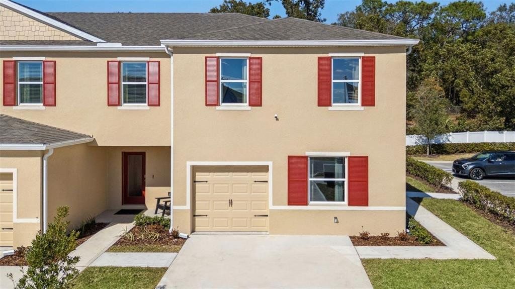 Front exterior of a new home in Oak Pointe, Apopka, FL, highlighting curb appeal (Image 1). Front exterior of a new home in Oak Pointe, Apopka, FL, highlighting curb appeal (Image 1).