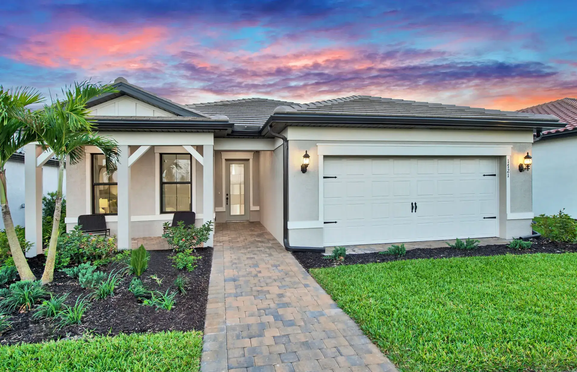 Front exterior of a new home in Terreno, Naples, FL, highlighting curb appeal (Image 1). Front exterior of a new home in Terreno, Naples, FL, highlighting curb appeal (Image 1).