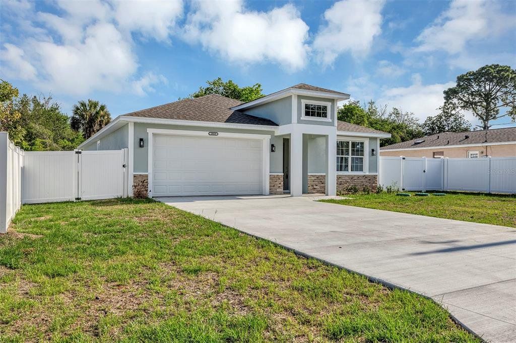 Front exterior of a new home in , Summerfield, FL, highlighting curb appeal (Image 1). Front exterior of a new home in , Summerfield, FL, highlighting curb appeal (Image 1).