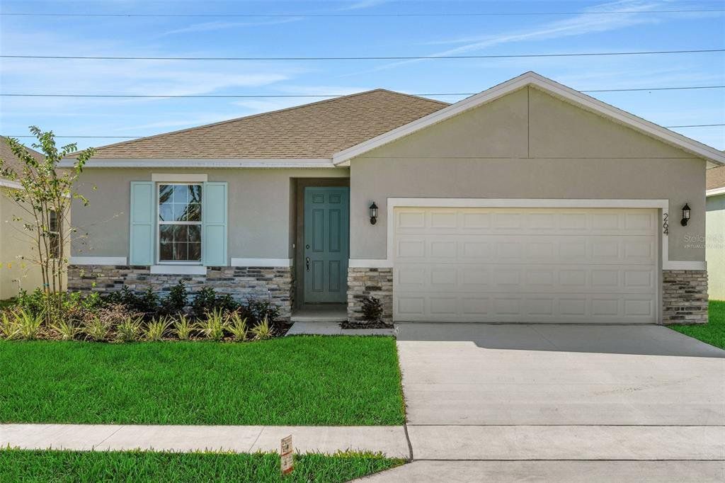 Front exterior of a new home in Willowbrook North, Winter Haven, FL, highlighting curb appeal (Image 1). Front exterior of a new home in Willowbrook North, Winter Haven, FL, highlighting curb appeal (Image 1).