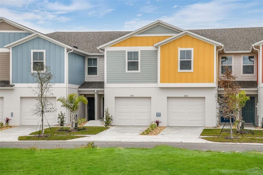 Front exterior of a new home in Grove at Crosswinds, Haines City, FL, highlighting curb appeal (Image 1). Front exterior of a new home in Grove at Crosswinds, Haines City, FL, highlighting curb appeal (Image 1).