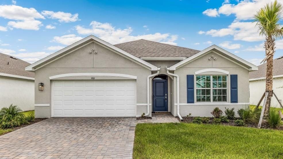 Front exterior of a new home in Seagrass - Express & Tradition, Punta Gorda, FL, highlighting curb appeal (Image 1). Front exterior of a new home in Seagrass - Express & Tradition, Punta Gorda, FL, highlighting curb appeal (Image 1).