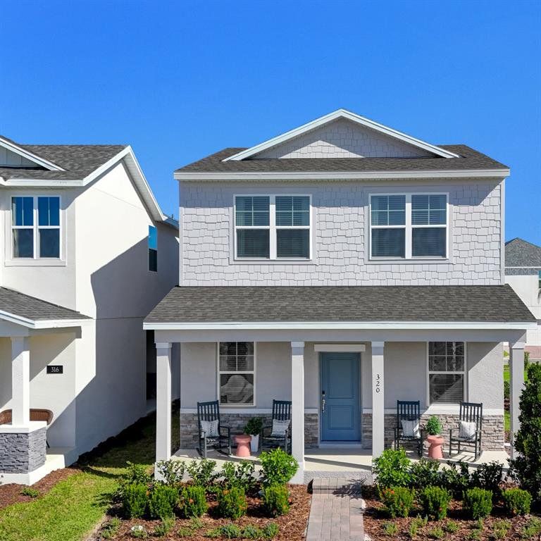 Front exterior of a new home in Spring Walk at the Junction, Debary, FL, highlighting curb appeal (Image 1). Front exterior of a new home in Spring Walk at the Junction, Debary, FL, highlighting curb appeal (Image 1).