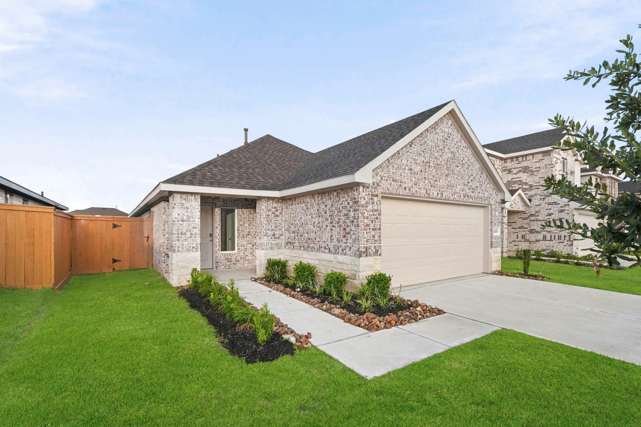 Front exterior of a new home in Sunterra, Katy, TX, highlighting curb appeal (Image 1). Front exterior of a new home in Sunterra, Katy, TX, highlighting curb appeal (Image 1).