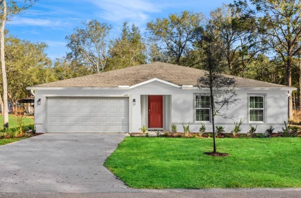 Front exterior of a new home in Royal Highlands, Weeki Wachee, FL, highlighting curb appeal (Image 1). Front exterior of a new home in Royal Highlands, Weeki Wachee, FL, highlighting curb appeal (Image 1).