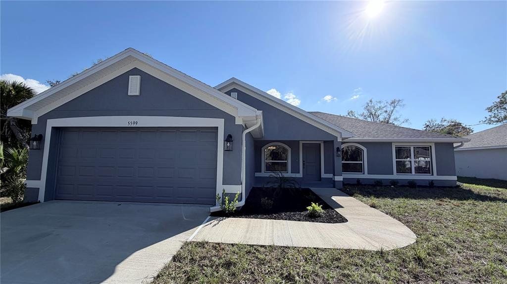 Front exterior of a new home in North Port, North Port, FL, highlighting curb appeal (Image 1). Front exterior of a new home in North Port, North Port, FL, highlighting curb appeal (Image 1).