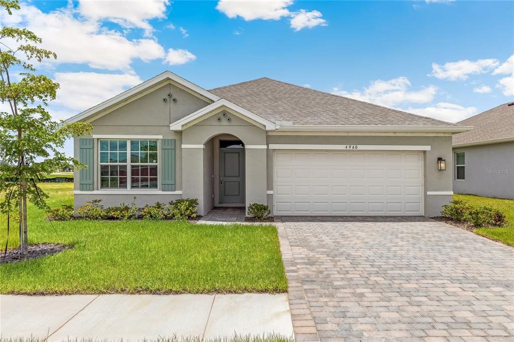 Front exterior of a new home in Coral Lakes - Tradition & Express, Punta Gorda, FL, highlighting curb appeal (Image 1). Front exterior of a new home in Coral Lakes - Tradition & Express, Punta Gorda, FL, highlighting curb appeal (Image 1).