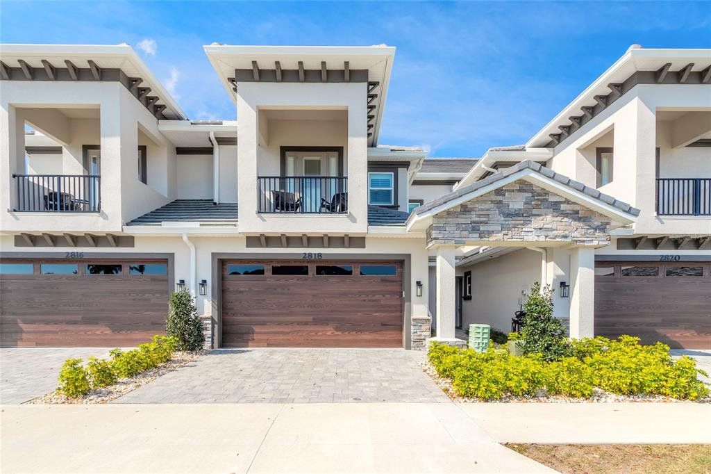 Front exterior of a new home in The Isles at Venetian Bay, New Smyrna Beach, FL, highlighting curb appeal (Image 1). Front exterior of a new home in The Isles at Venetian Bay, New Smyrna Beach, FL, highlighting curb appeal (Image 1).