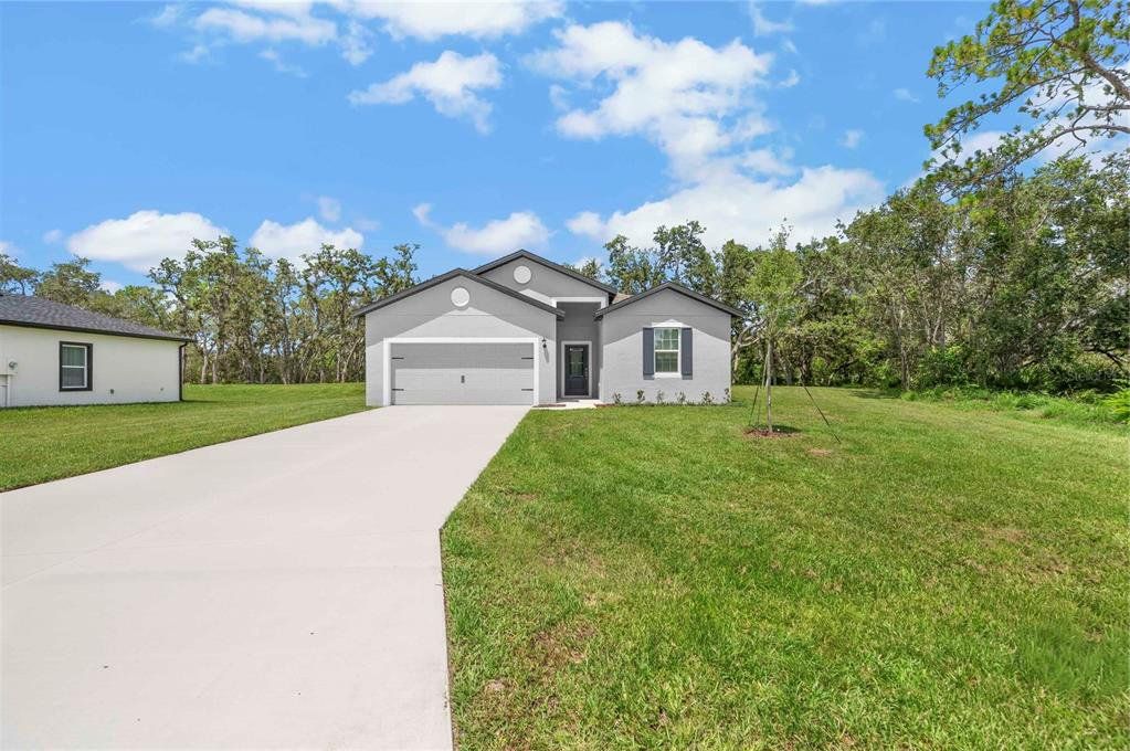 Front exterior of a new home in Poinciana, Poinciana, FL, highlighting curb appeal (Image 1). Front exterior of a new home in Poinciana, Poinciana, FL, highlighting curb appeal (Image 1).
