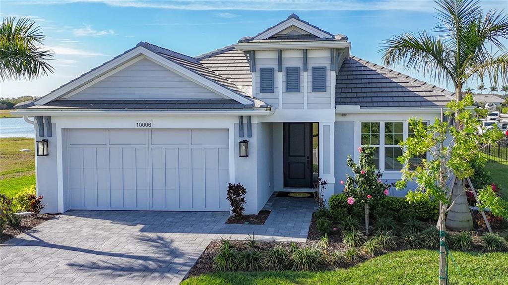 Front exterior of a new home in Inspiration at Watercolor Place, Bradenton, FL, highlighting curb appeal (Image 1). Front exterior of a new home in Inspiration at Watercolor Place, Bradenton, FL, highlighting curb appeal (Image 1).