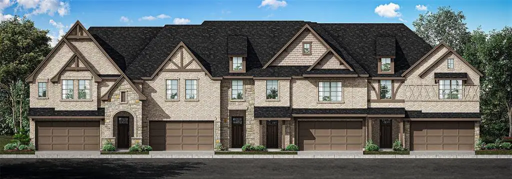 View of front of house with stone siding, a garage, and driveway