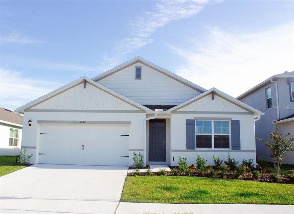 Front exterior of a new home in Kindred, Kissimmee, FL, highlighting curb appeal (Image 1). Front exterior of a new home in Kindred, Kissimmee, FL, highlighting curb appeal (Image 1).