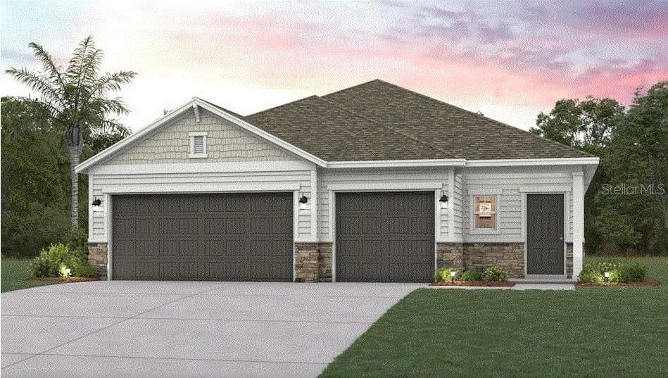 Front exterior of a new home in The Magnolia Series at Reserve East, Flagler Beach, FL, highlighting curb appeal (Image 1).