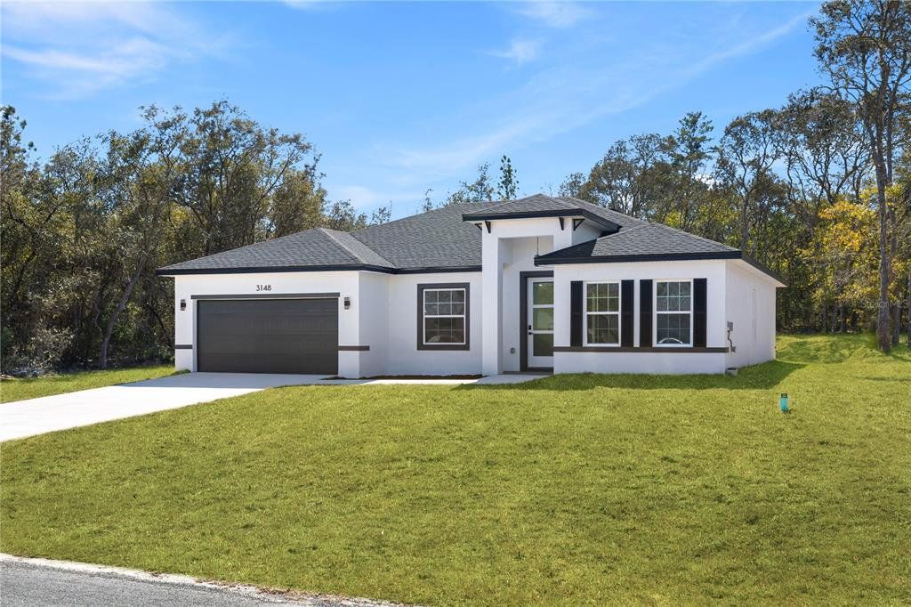 Front exterior of a new home in , Citrus Springs, FL, highlighting curb appeal (Image 1). Front exterior of a new home in , Citrus Springs, FL, highlighting curb appeal (Image 1).