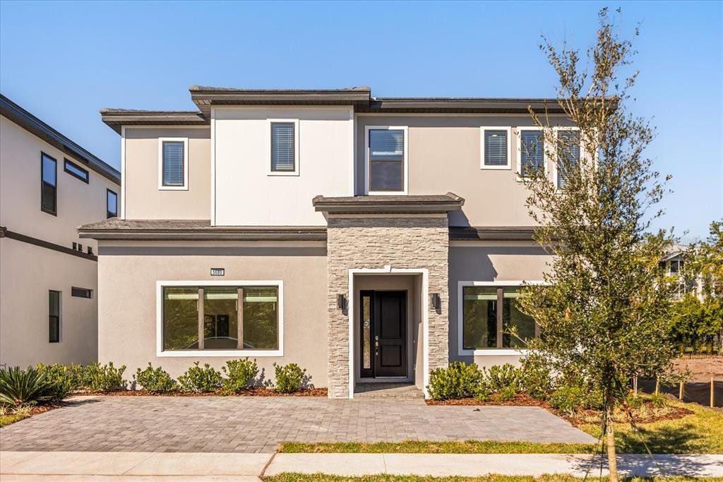 Front exterior of a new home in Paradiso Grande Resort, Orlando, FL, highlighting curb appeal (Image 1). Front exterior of a new home in Paradiso Grande Resort, Orlando, FL, highlighting curb appeal (Image 1).