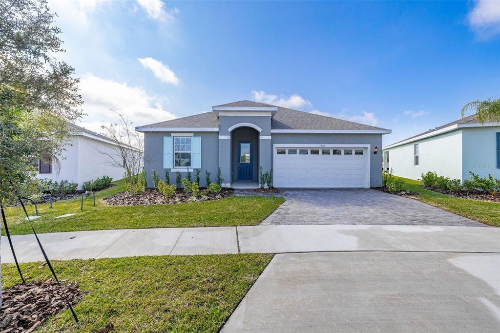 Front exterior of a new home in Reserve at Hammock Oaks, Lady Lake, FL, highlighting curb appeal (Image 1). Front exterior of a new home in Reserve at Hammock Oaks, Lady Lake, FL, highlighting curb appeal (Image 1).