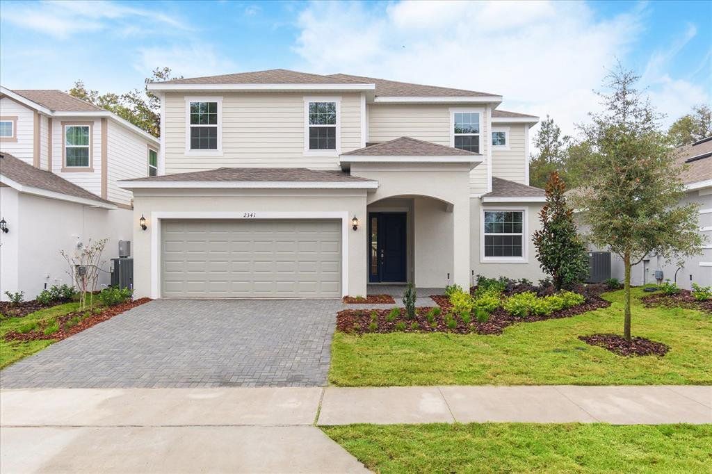 Front exterior of a new home in Summerbrooke, Mount Dora, FL, highlighting curb appeal (Image 1). Front exterior of a new home in Summerbrooke, Mount Dora, FL, highlighting curb appeal (Image 1).