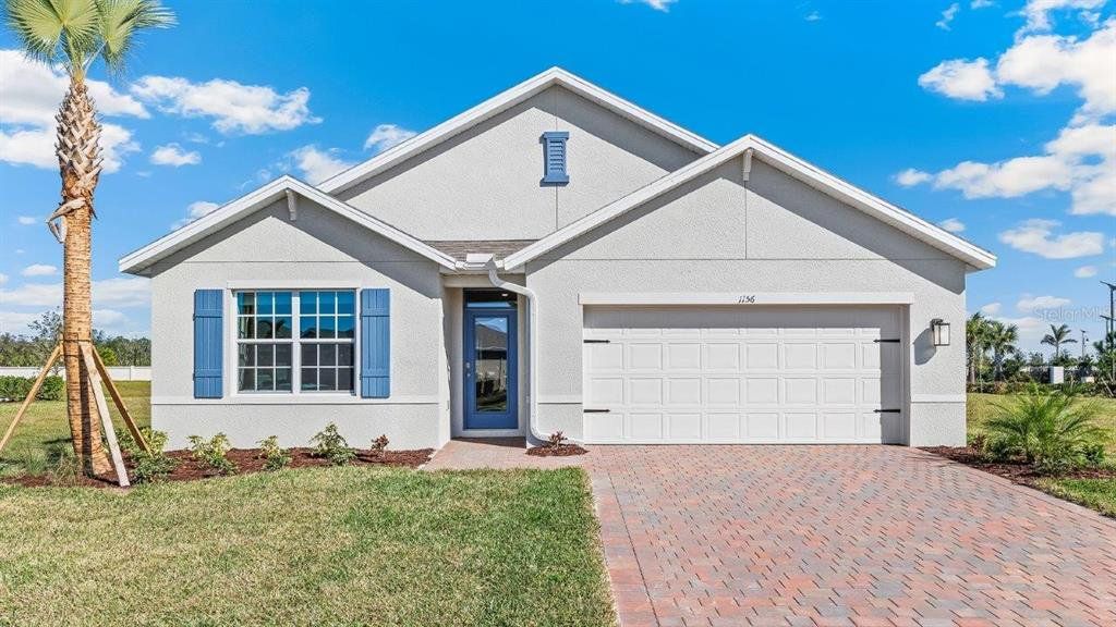 Front exterior of a new home in Coral Lakes - Tradition & Express, Punta Gorda, FL, highlighting curb appeal (Image 1). Front exterior of a new home in Coral Lakes - Tradition & Express, Punta Gorda, FL, highlighting curb appeal (Image 1).